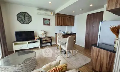 Charming living room with modern decor and open kitchen layout in a cozy apartment.