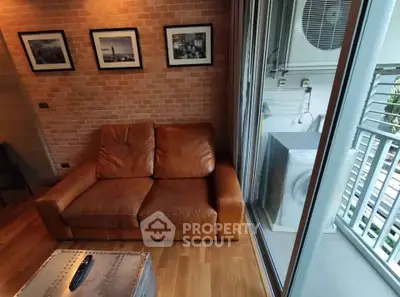 Cozy living room with leather sofa and balcony view