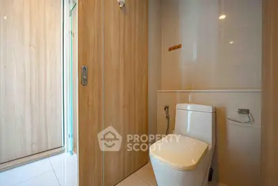 Modern bathroom with sleek wooden paneling and contemporary toilet design.