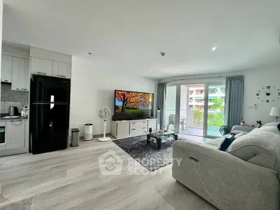 Spacious modern living room with open kitchen and balcony view in luxury apartment.