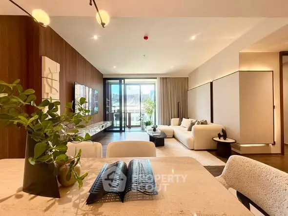 Luxurious modern living room with elegant decor and spacious layout, featuring a large window with natural light.