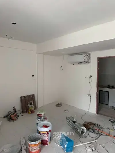 Under-construction interior space with tools and materials, showcasing renovation potential.