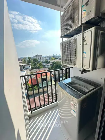 Charming balcony with city view and modern washing machine, perfect for urban living convenience.
