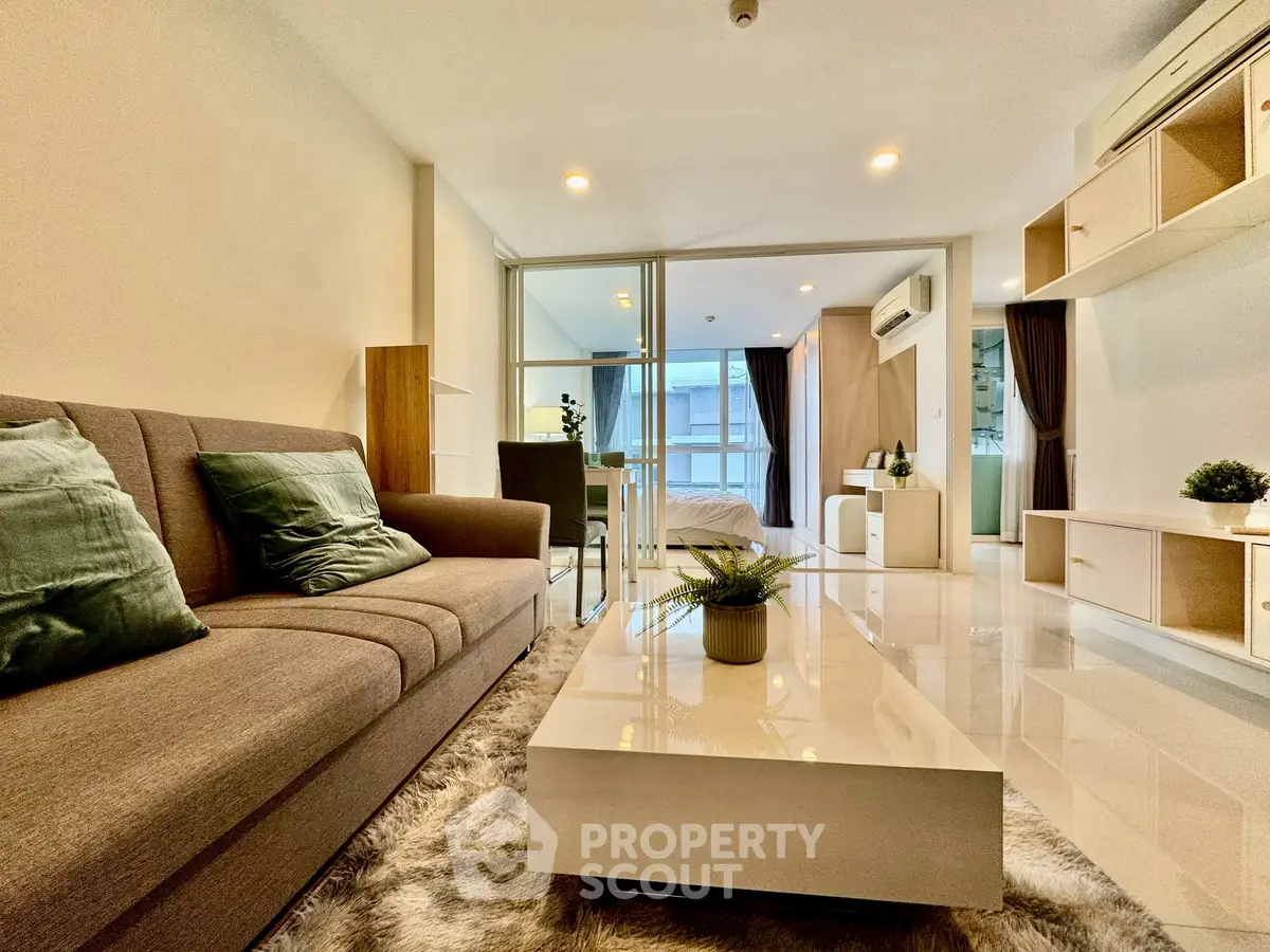 Modern living room with sleek furniture and open layout in a stylish apartment.