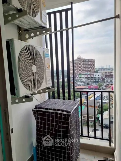 Compact balcony with air conditioning units and city view, ideal for urban living.