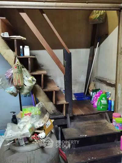 Rustic wooden staircase with cleaning supplies in a cozy home corner