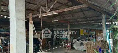 Spacious rustic open-air structure with exposed beams and eclectic decor, ideal for creative renovation.