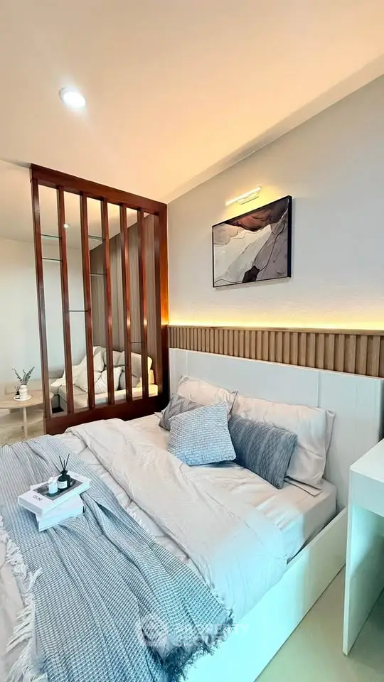 Modern bedroom with stylish decor and cozy ambiance, featuring elegant bedding and contemporary artwork.