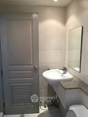 Modern bathroom with sleek sink and mirror in stylish apartment