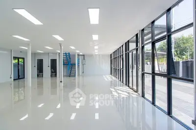 Spacious modern commercial space with large windows and glossy floors