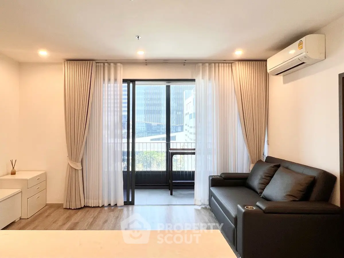 Modern living room with balcony view and sleek furnishings