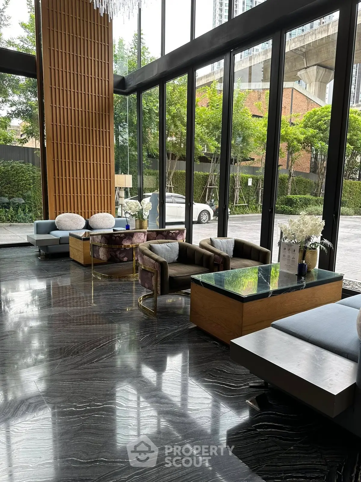 Luxurious modern lobby with floor-to-ceiling windows and elegant furnishings.