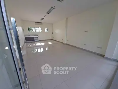 Spacious unfurnished room with large windows and tiled flooring, ideal for customization.