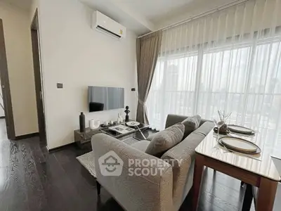 Modern living room with city view, featuring sleek furniture and elegant decor.