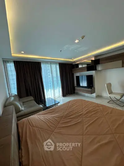 Luxurious living room with modern decor and large windows offering city views.