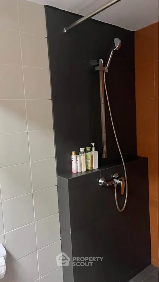 Modern bathroom shower area with sleek tiles and fixtures