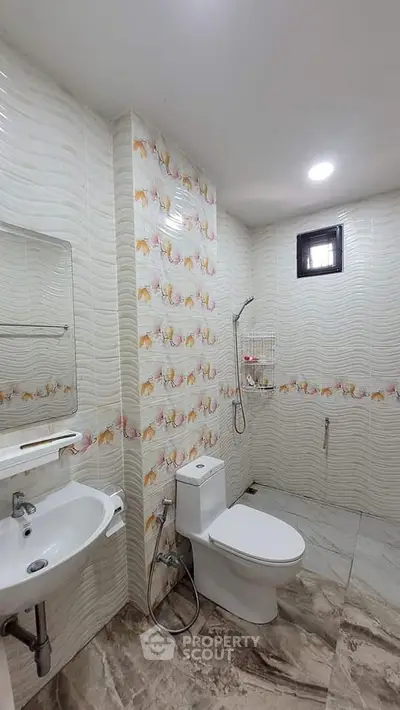 Modern bathroom with stylish tiles and sleek fixtures in a contemporary home.