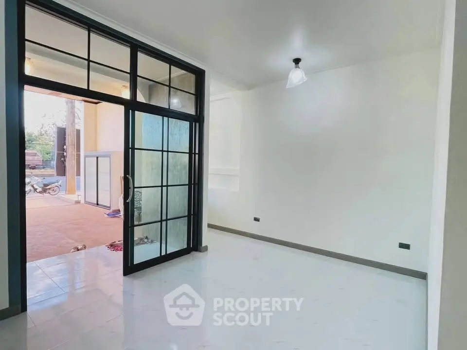 Spacious interior with glass doors leading to a patio, perfect for modern living.