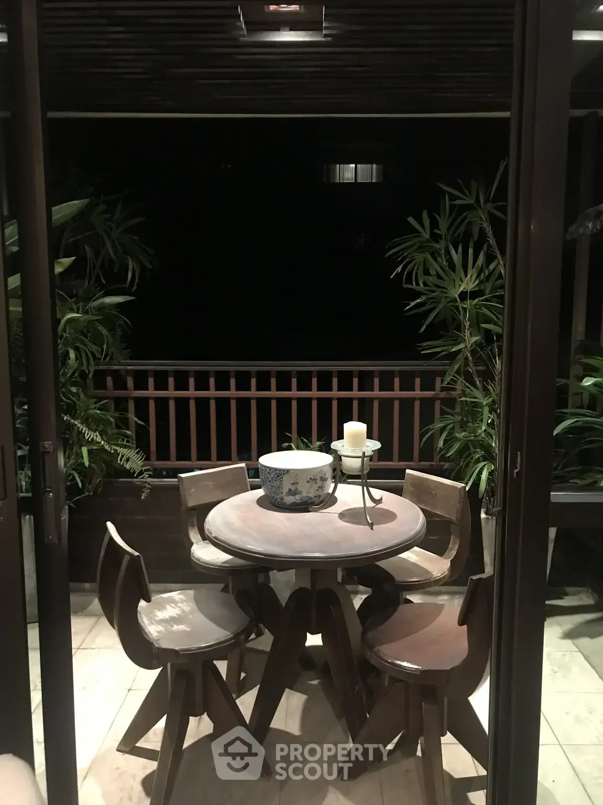 Charming balcony with cozy seating and lush greenery, perfect for relaxing evenings.