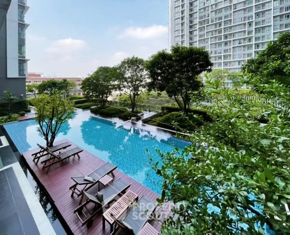 Luxurious apartment complex with stunning pool and lush greenery, perfect for relaxation and leisure.
