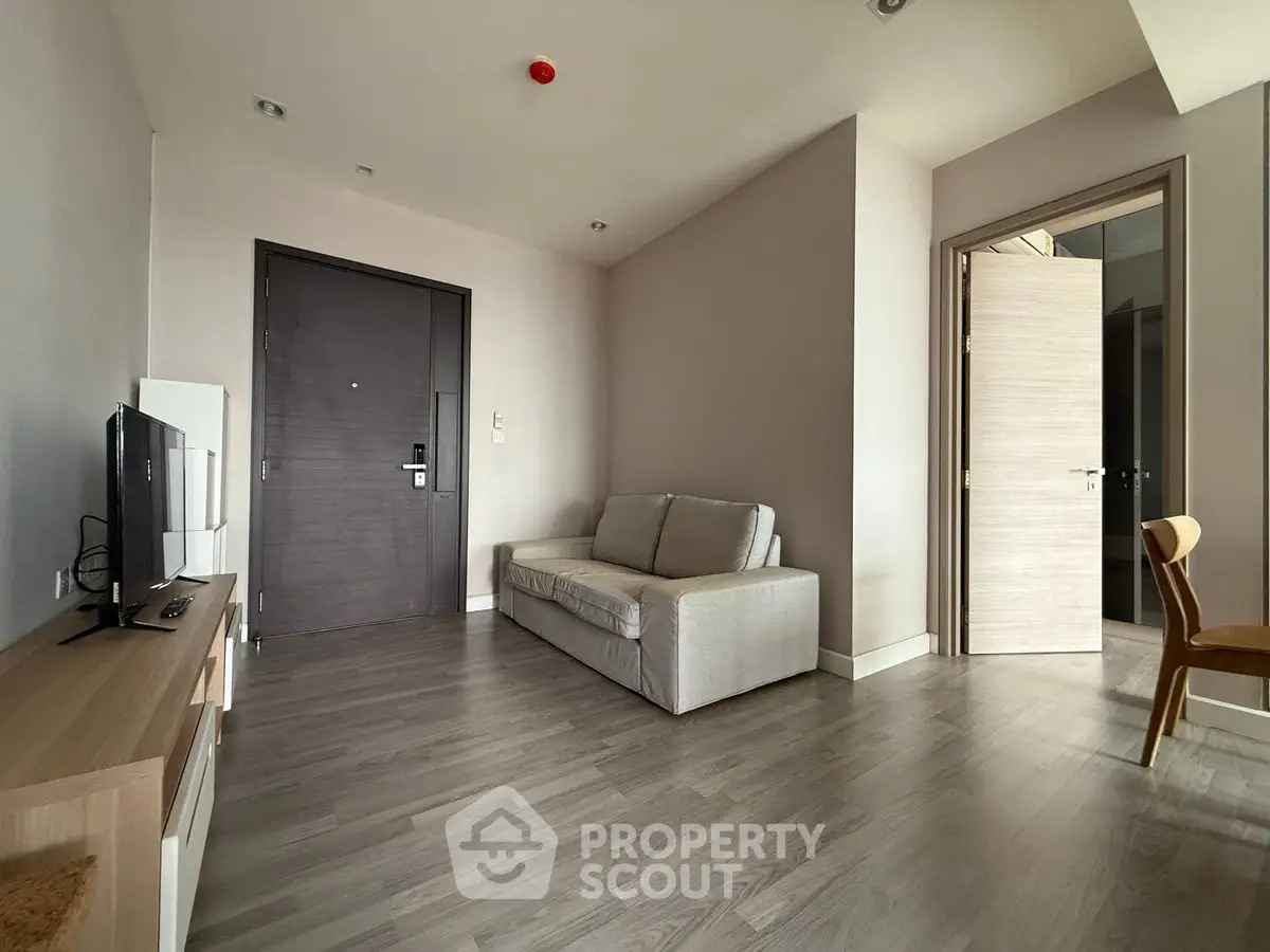 Modern living room with sleek wooden flooring and minimalist furniture design.