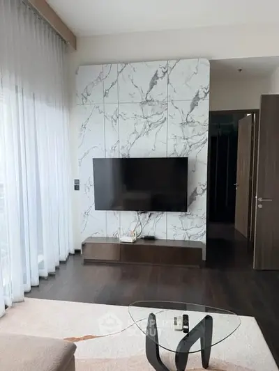 Modern living room with marble accent wall and sleek TV setup