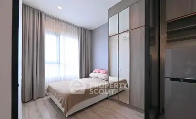 Modern bedroom with mirrored wardrobe and natural light