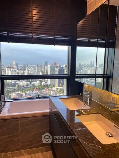 Luxurious bathroom with city view, featuring double sinks and a bathtub, perfect for relaxation.