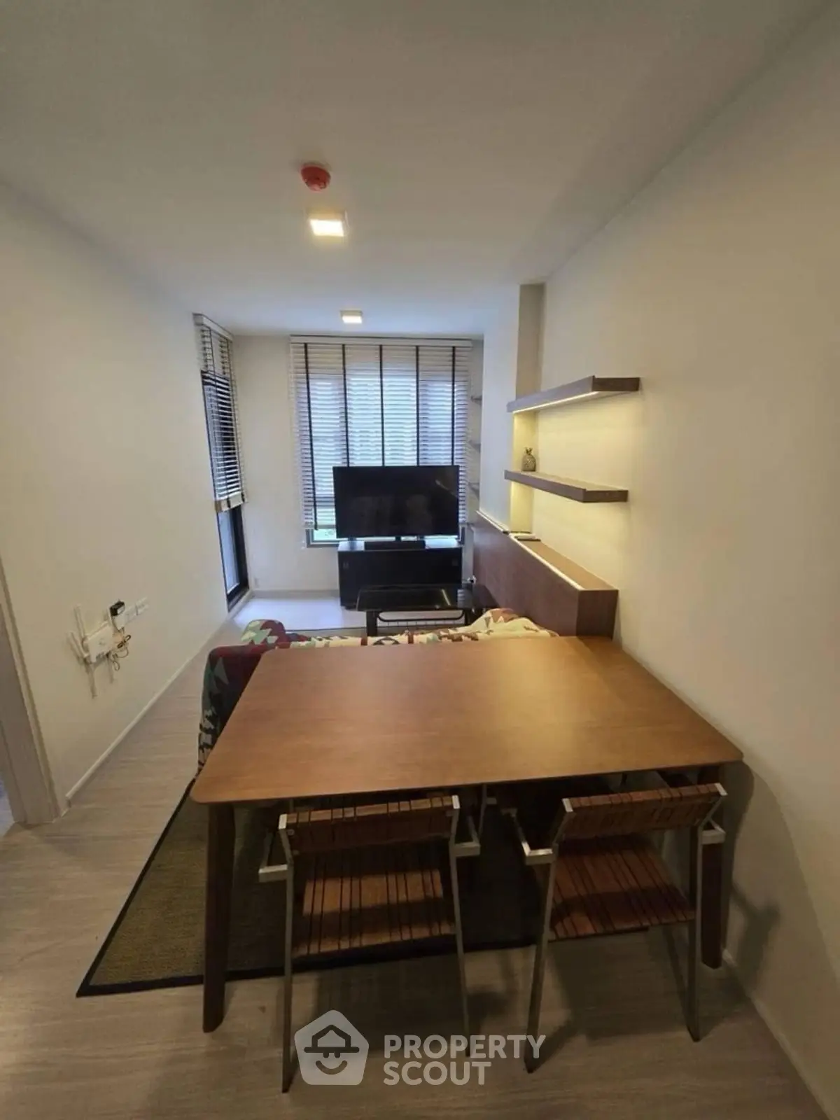 Modern living room with stylish furniture and TV, perfect for cozy gatherings.
