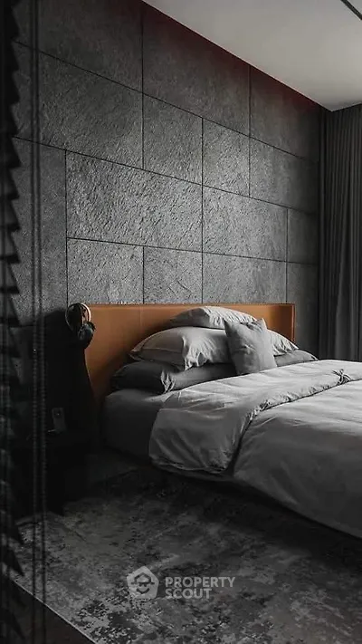 Luxurious modern bedroom with textured wall and elegant bedding