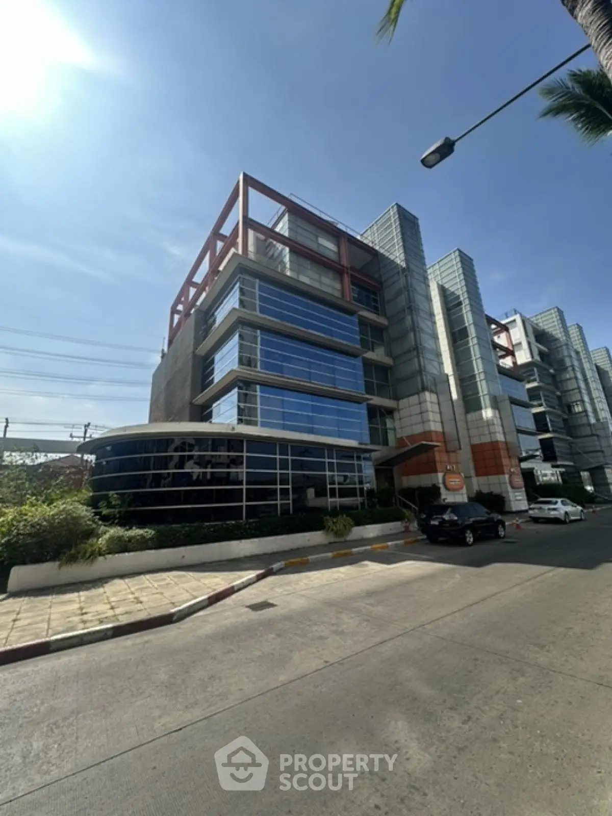 Modern commercial building with glass facade and unique architectural design