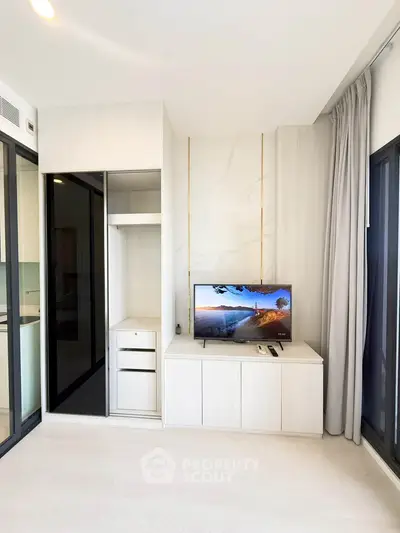 Modern living room with sleek TV setup and elegant cabinetry
