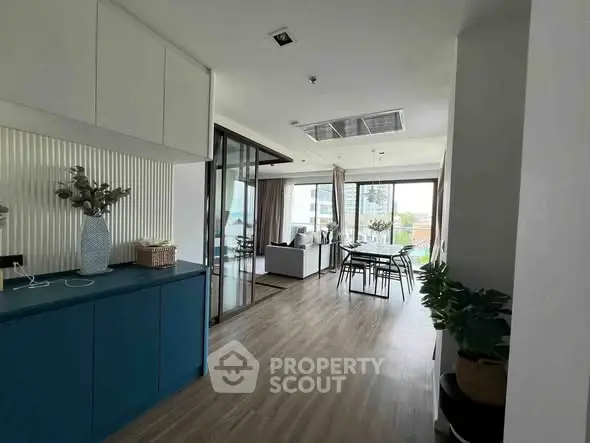 Spacious modern living room with open layout and large windows offering a stunning view.