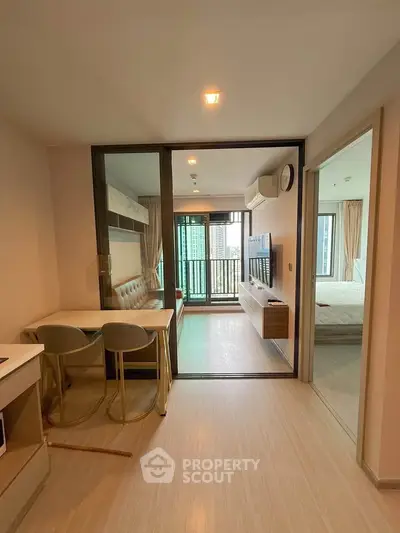 Modern apartment interior with open layout, featuring a cozy living area and stylish dining space.