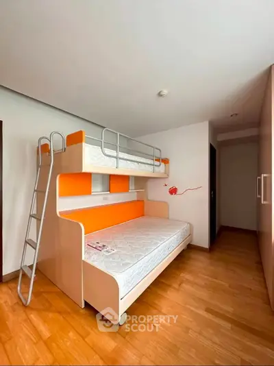 Modern bedroom with stylish bunk bed and wooden flooring