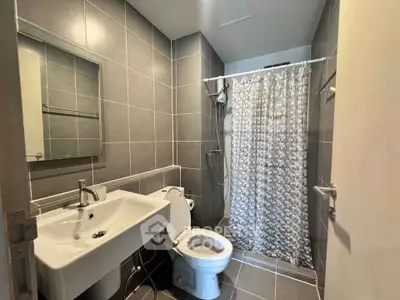 Modern bathroom with sleek gray tiles and contemporary fixtures