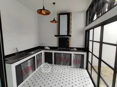 Stylish modern kitchen with black countertops and white brick walls