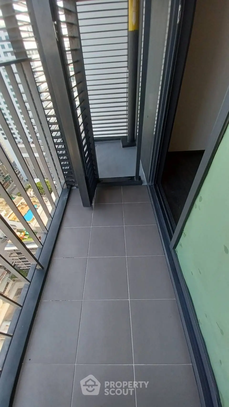 Modern apartment balcony with sleek design and city view.