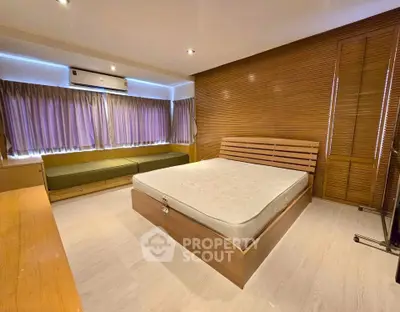 Spacious bedroom with modern design and ample natural light