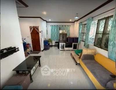 Spacious living room with modern decor and large windows for natural light.