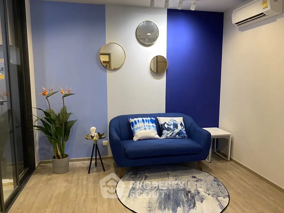 Modern living room with blue accent wall and stylish decor