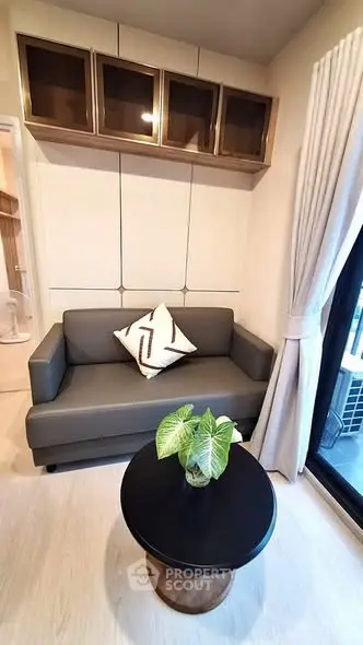 Cozy living room with modern sofa, stylish coffee table, and elegant curtains in a chic apartment.