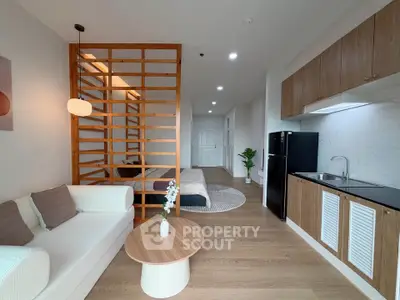 Modern open-plan living room with stylish kitchen and cozy seating area