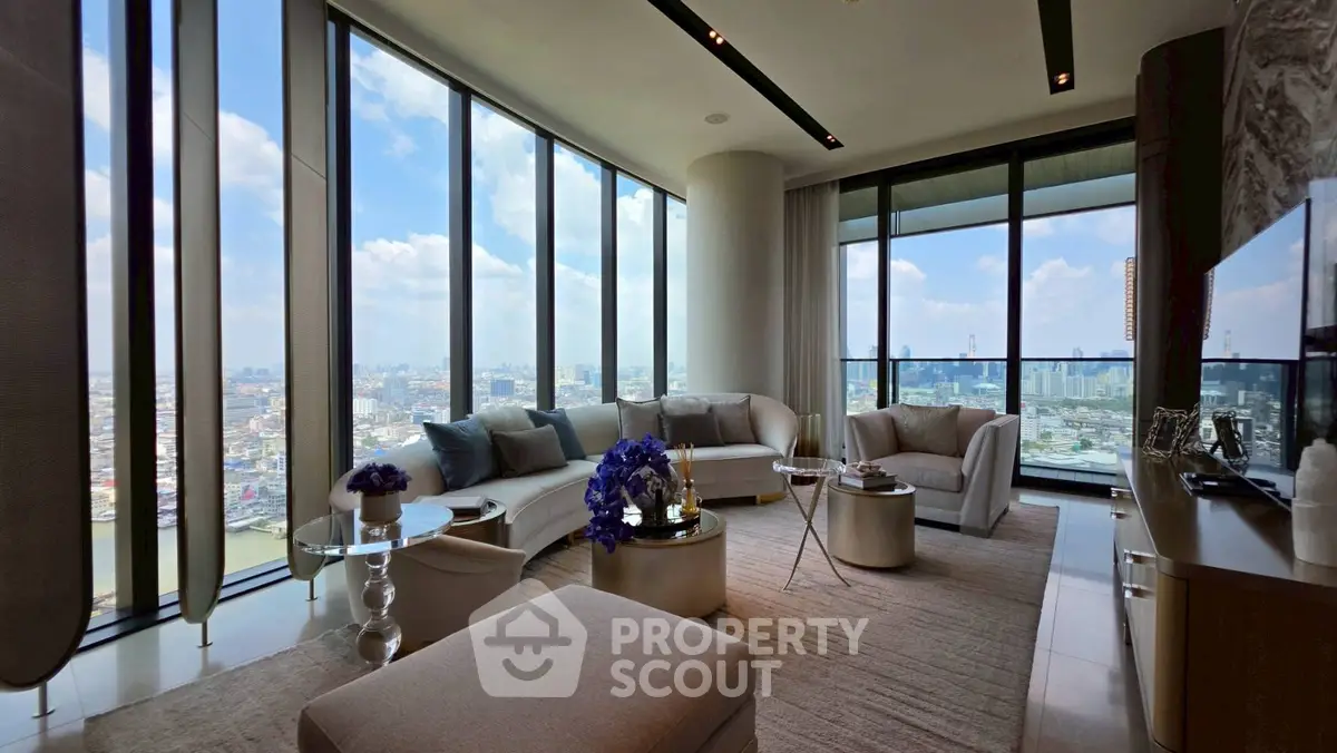 Luxurious high-rise living room with panoramic city views and elegant modern furnishings.