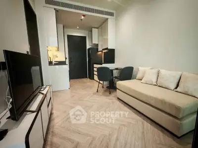 Modern living room with sleek furniture and open kitchen layout