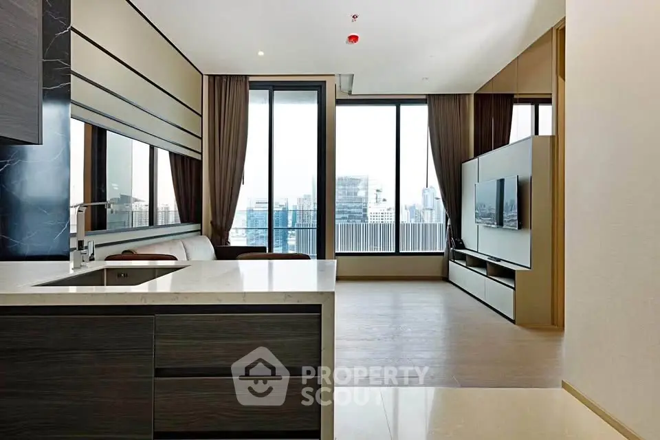 Modern open-plan living room with city view and sleek kitchen design