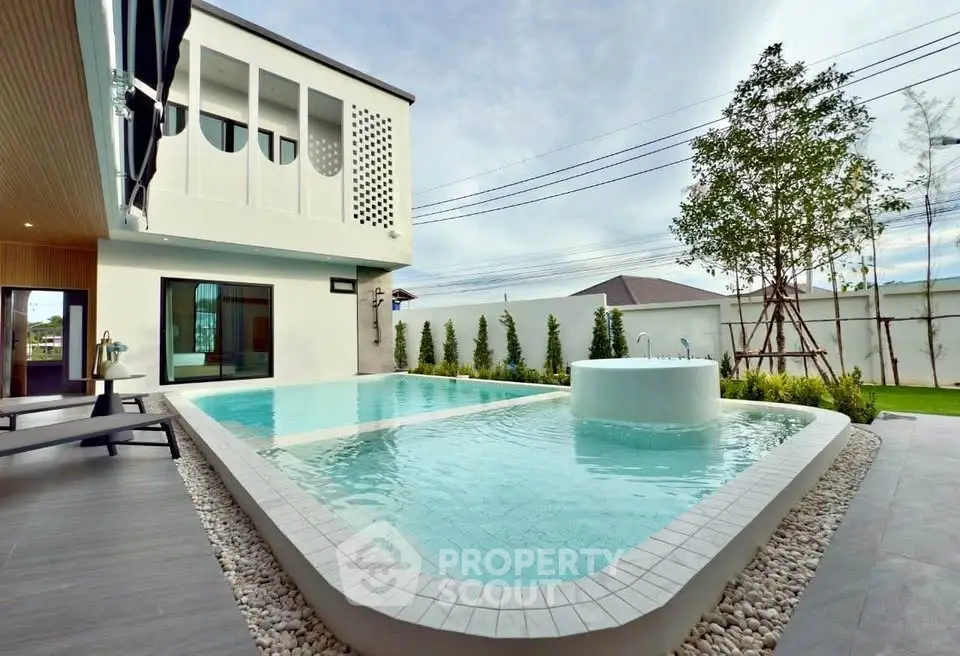 Luxurious modern home with stunning pool and spacious outdoor area.