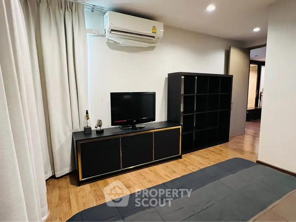 Modern bedroom with sleek black furniture and air conditioning unit