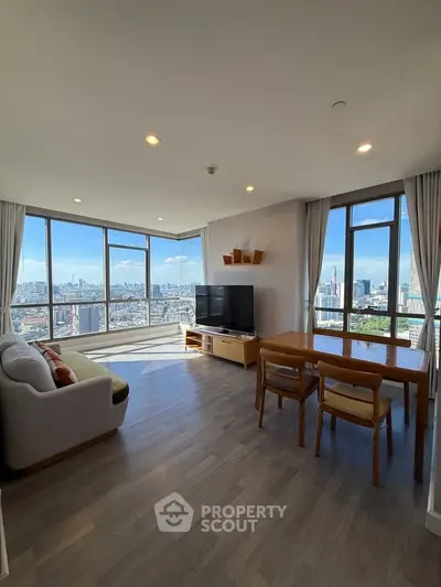 Spacious living room with panoramic city views and modern furnishings