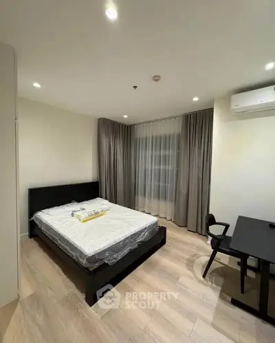 Modern bedroom with sleek furniture and natural lighting.